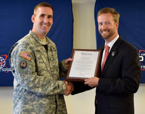 Col William Russell and Mr. Brendan Burke shake hands.