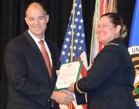 Two people hold certificate.