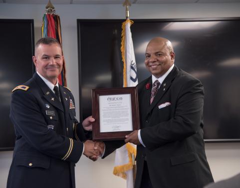 Col. R.J. Mikesh, left, and Keith Baylor, right, at the AMIS assumption ...