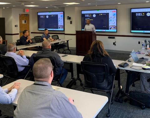 Carlton White, product director for GFEBS, speaks to his team at a GFEBS meeting, November 2024, in Crystal City, Virginia. 