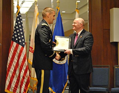 Mr. Daniel Kitts accepts the Charter for GFEBS DEV MOD from COL Matt Russell, PM GFEBS, in a ceremony held June 15.