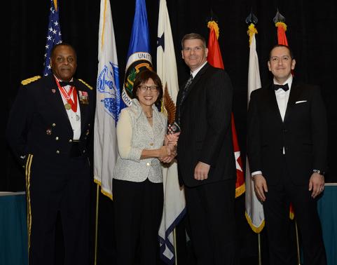 Mr. Michael McAllister, logistics management specialist, Medical Communications for Combat Casualty Care (MC4) is presented the Logistician of the Year 2015 award