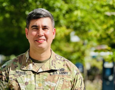 Photo of Maj. Ryan Nehus outside the Polk Building in Crystal City, Virginia