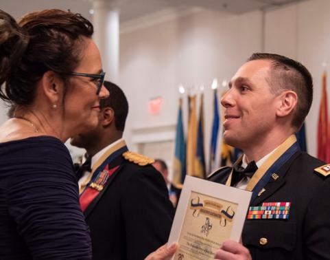 Ms. Smith presents Capt. Lucas Sawtelle with the Quartermaster Order of Saint Martin Award. 