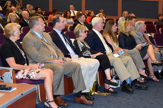 Crowd sitting in auditorium.