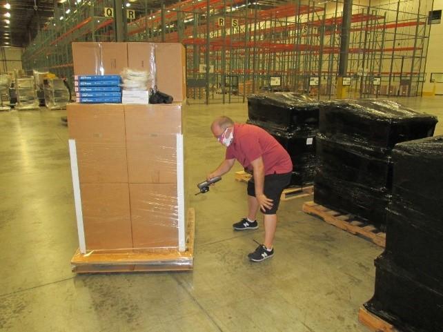 Rennie Glazer, an HSIF support contactor, verifies quantities and equipment on an outbound National Guard order 