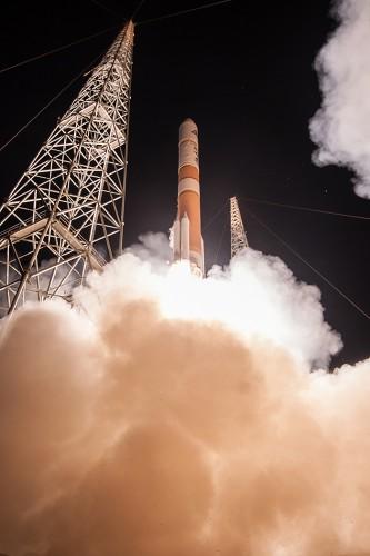 Satellite launching with smoke around it.